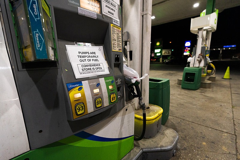 A pump at a gas station in Silver Spring, Md., is out of service, notifying customers they are out of fuel, Thursday, May 13, 2021. Motorists found gas pumps shrouded in plastic bags at tapped-out service stations across more than a dozen U.S. states Thursday while the operator of the nation's largest gasoline pipeline reported making "substantial progress" in resolving the computer hack-induced shutdown responsible for the empty tanks. (AP Photo/Manuel Balce Ceneta)