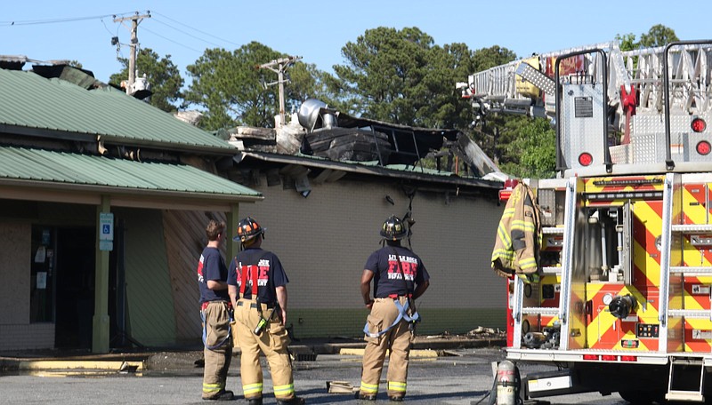 Firefighters with the Little Rock Fire Department look at Sims Bar-B-Que after a fire was put out Friday afternoon, May 14, 2021. Fire Department spokesman Capt. Doug Coffman said the fire is likely not suspicious. (Arkansas Democrat-Gazette/William Sanders)