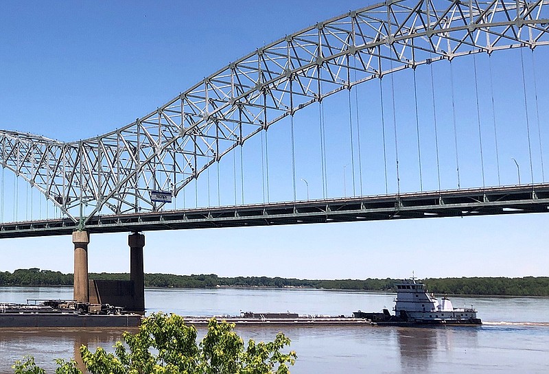 A tugboat pushes barges under the Interstate 40 bridge Friday at Memphis. The Mississippi River reopened to barge traffic Friday.
(AP/Adrian Sainz)