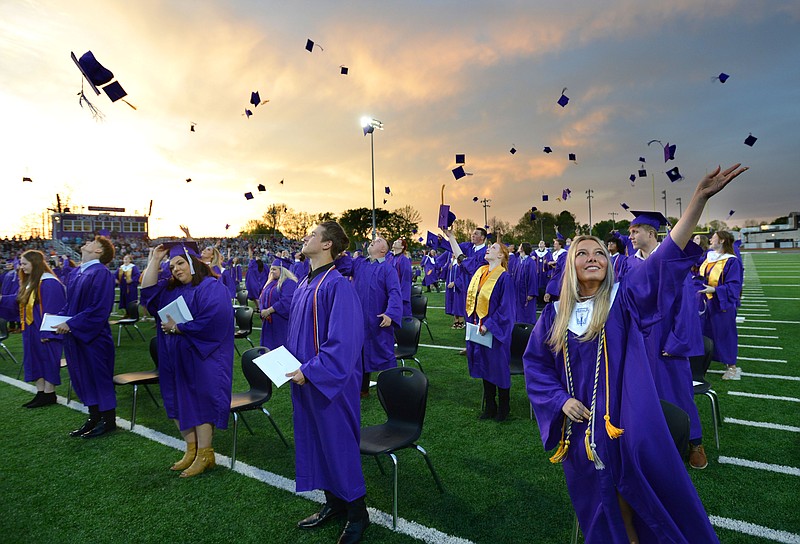 Lilli Carmen (right) joins other members of the 2021 senior class at Elkins High School in tossing her mortar board Friday, May 14, 2021, after receiving her diploma during commencement exercises at the school’s football field. The school graduated 95 seniors. Visit nwaonline.com/210515Daily/ for today's photo gallery.
(NWA Democrat-Gazette/Andy Shupe)