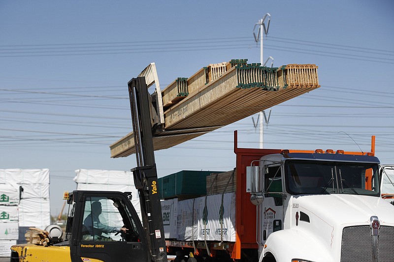 A worker operates a forklift to load floor joist on a delivery truck at Burton Lumber in Salt Lake City, Utah, on May 6, 2021. MUST CREDIT: Bloomberg photo by George Frey.