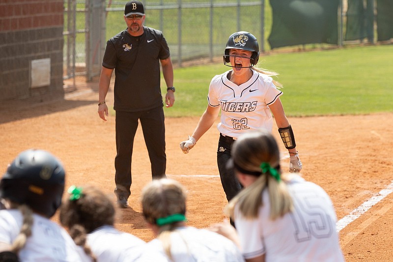 Bentonville’s Kenzie Derryberry runs to her team to celebrate after hitting a home run Saturday during the Class 6A state softball semifinals against Bryant at Cabot softball complex. (Arkansas Democrat-Gazette/Justin Cunningham)