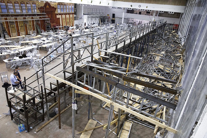 Israeli police officers walk inside an empty synagogue in Givat Zeev outside Jerusalem on Sunday, May 16, 2021. Israeli medics say more than 150 people were injured in a fatal collapse of the bleachers at the uncompleted West Bank synagogue. (AP/Sebastian Scheiner)