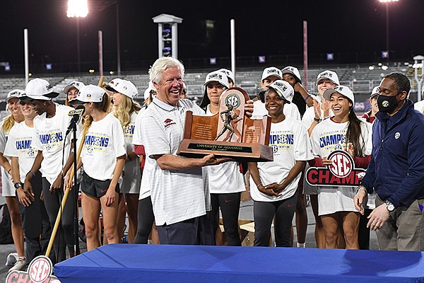 Arkansas coach Lance Harter holds the SEC championship trophy after the Razorbacks won the team title at the SEC Outdoor Track and Field Championships on Saturday, May 15, 2021, in College Station, Texas. (Photo by Craig Bisacre, Texas A&M Athletics)