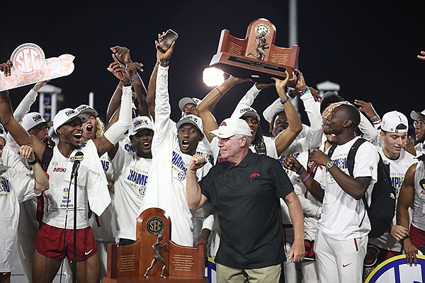 Arkansas coach Chris Bucknam (front) celebrates with his athletes after the Razorbacks won the team title at the SEC Outdoor Track and Field Championships on Saturday, May 15, 2021, in College Station, Texas. (Photo by Craig Bisacre, Texas A&M Athletics)
