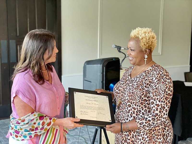 School Board President Renee Skinner presented retiree Shirley Randle with a plaque honoring her years of service in the school district. Randle was one of nine retirees honored last Thursday at the El Dorado Gold and Country Club. (Marvin Richards/News-Times)