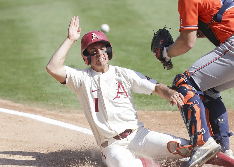 Arkansas infielder Robert Moore (1) runs home for a score, Saturday, April 3, 2021 during the sixth inning of a baseball game at Baum-Walker Stadium in Fayetteville. Check out nwaonline.com/210404Daily/ for today's photo gallery. .(NWA Democrat-Gazette/Charlie Kaijo)