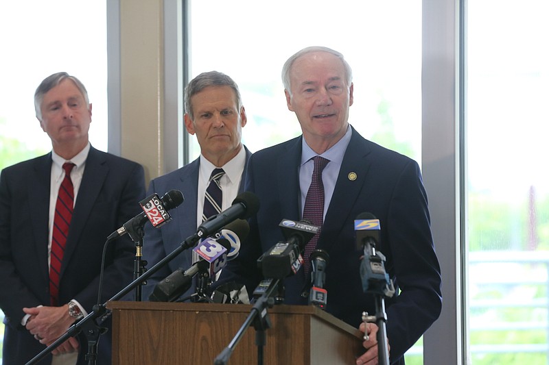 Gov. Asa Hutchinson (right), Tennessee Gov. Bill Lee (center) and Tennessee Department of Transportation Commissioner Clay Bright (left) hold a press conference to discuss repairs to the I-40 bridge on Tuesday, May 18, 2021, in Memphis, Tennessee. (Arkansas Democrat-Gazette/Thomas Metthe)