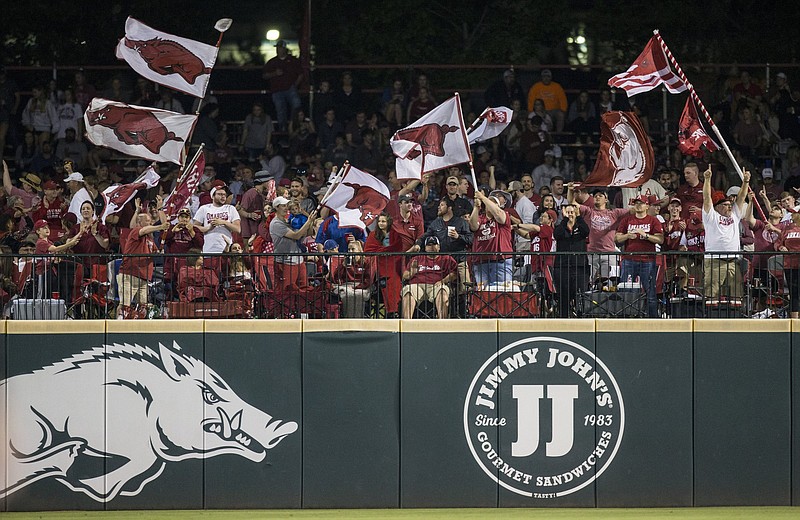 Arkansas fans celebrate a hit during a game at Baum-Walker Stadium in Fayetteville during the 2019 season. For the fi rst time this season, the stadium can have full capacity for this weekend’s series against Florida, which begins tonight.
(NWA Democrat-Gazette file photo)