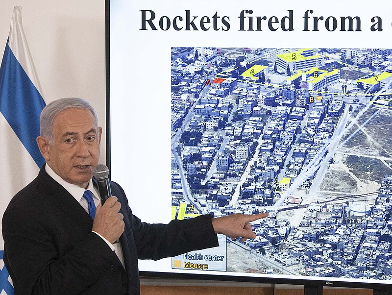 Israeli Prime Minister Benjamin Netanyahu indicates an image showing what he said were rockets fired from a civilian area of Gaza during a briefi ng Wednesday for ambassadors to Israel at the Hakirya military base in Tel Aviv. Rebuffing President Joe Biden’s call for easing Israel’s offensive, Netanyahu said he was “determined to continue this operation until its aim is met.”
(AP/Sebastian Scheiner)