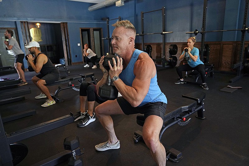 Scott Johnson works out in a fitness class Friday in Studio City, Calif. California plans to drop social distancing and capacity requirements for businesses when the state reopens on June 15.
(AP/Marcio Jose Sanchez)