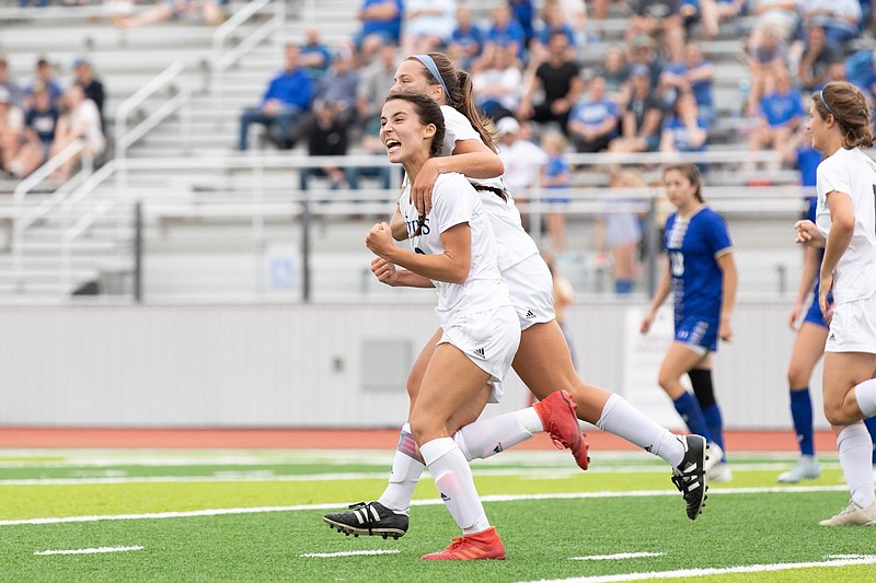 Pulaski Academy’s Maria Sanhudo celebrates with a teammate after scoring in Friday’s Class 4A girls soccer state championship game at the Benton Athletic Complex. Sanhudo had two goals to lead the Lady Bruins to a 4-0 victory as they completed an unbeaten season. More photos at arkansasonline.com/522girls4a/
(Arkansas Democrat-Gazette/Justin Cunningham)