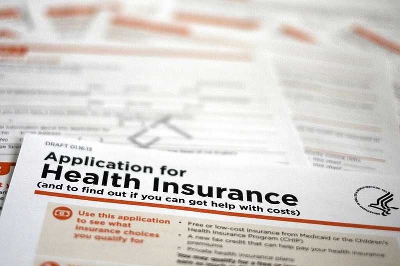 An early version of a 21-page insurance application form from the U.S. Department of Health and Human Services is shown in this March 2013 file photo. (AP/J. David Ake)