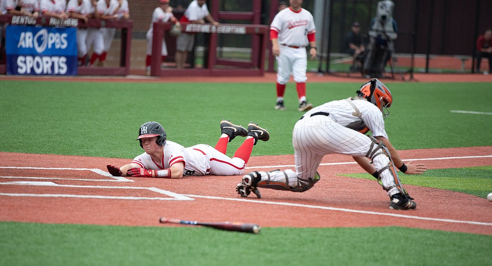 Harding Academy’s Eli Wallis slides safely into home during the Class 3A state championship game against Walnut Ridge on Friday. The Wildcats won 8-1 to earn the school’s third state title this school year. More photos at www.arkansasonline.com/522boys53a/
(Arkansas Democrat-Gazette/Justin Cunningham)