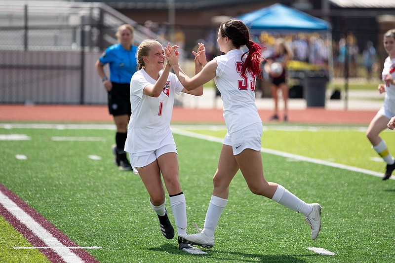 Harding Academy’s Anna Snow (right) celebrates with teammate Nora Henderson after scoring a goal Saturday against Green Forest in the Class 3A girls soccer state championship match at the Benton Athletic Complex. The Lady Wildcats earned their first state championship with a 6-2 victory. More photos are available at arkansasonline.com/523girlssoccer/
(Arkansas Democrat-Gazette/Justin Cunningham)