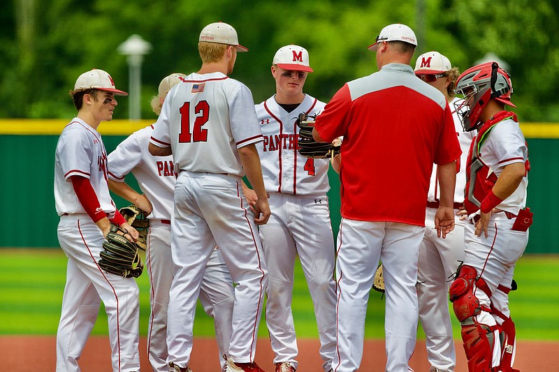 Magnolia head coach Bobby Beeson visits with pitcher Seth Edwards (4) and the infield during Saturday’s Class 4A State Championship game in Benton. The Panthers lost 8-1 and finished as runners-up.