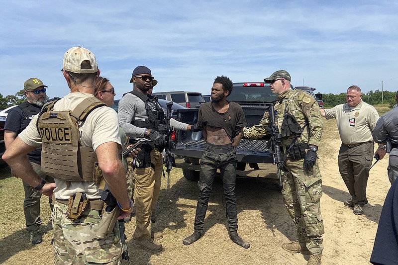 In this photo provided by the Chester County Sheriff’s Office, Tyler Terry is arrested in South Carolina on Monday, May 24, 2021. A weeklong manhunt for Terry, a suspect wanted in the killings of four people, ended without another shot fired as hundreds of officers surrounded him, authorities said.