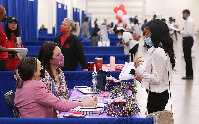 Claire's store manager Raven Roberson (left) and district manager Gabrielle Hansbro talk with Makayla Haney (right), 18, about job openings during the City of Little Rock Summer Youth Employment Job Fair on Thursday, May 27, 2021, at the Arkansas State Fairgrounds. (Arkansas Democrat-Gazette/Thomas Metthe)