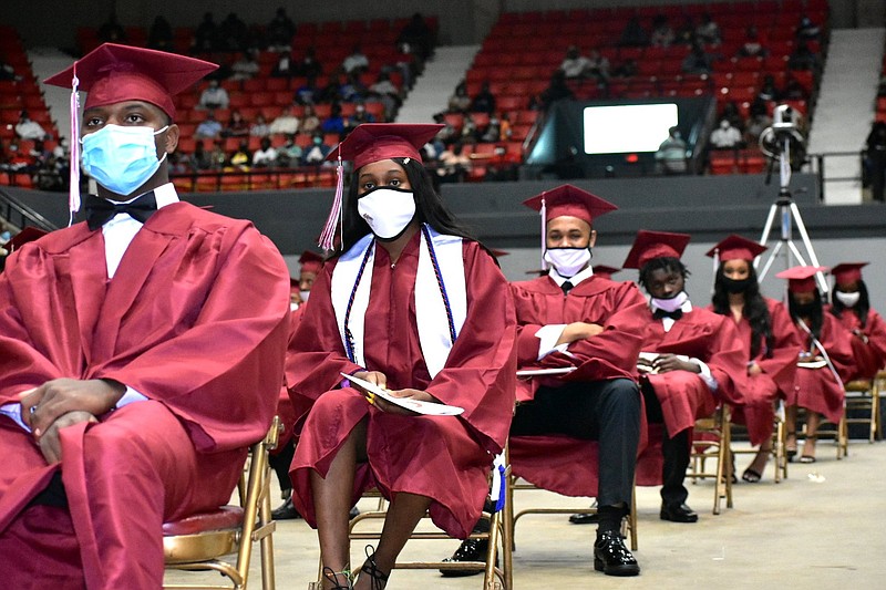 Pine Bluff High School graduates relax on the Pine Bluff Convention Center arena floor during their ceremony on May 21. 
(Pine Bluff Commercial/I.C. Murrell)