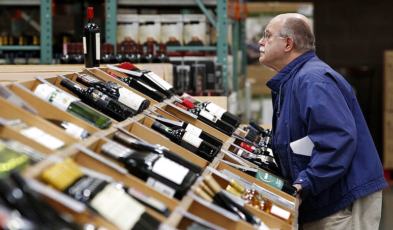 Pat Kenyon looks over the wine selection as he shops at a Costco warehouse store in Seattle in this Oct. 31, 2011, file photo. (AP/Elaine Thompson)