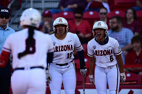 Arizona's Sharlize Palacios (18) and Janelle Meoño (6) wait as Dejah Mulipola (8) runs toward home plate after Mulipola hit a home run during an NCAA super regional game against Arkansas on Friday, May 28, 2021, in Fayetteville.