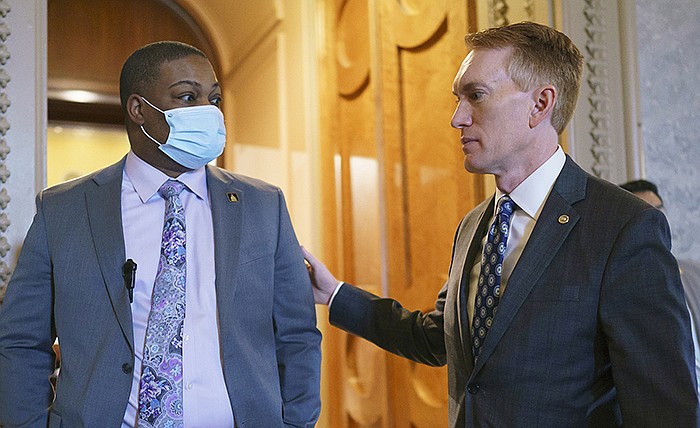 U.S. Capitol Police officer Eugene Goodman (left), who diverted rioters from the Senate chamber on Jan. 6, gets a greeting Friday from Sen. James Lankford, R-Okla., after Lankford joined in voting against an independent investigation of the insurrection.
(AP/J. Scott Applewhite)