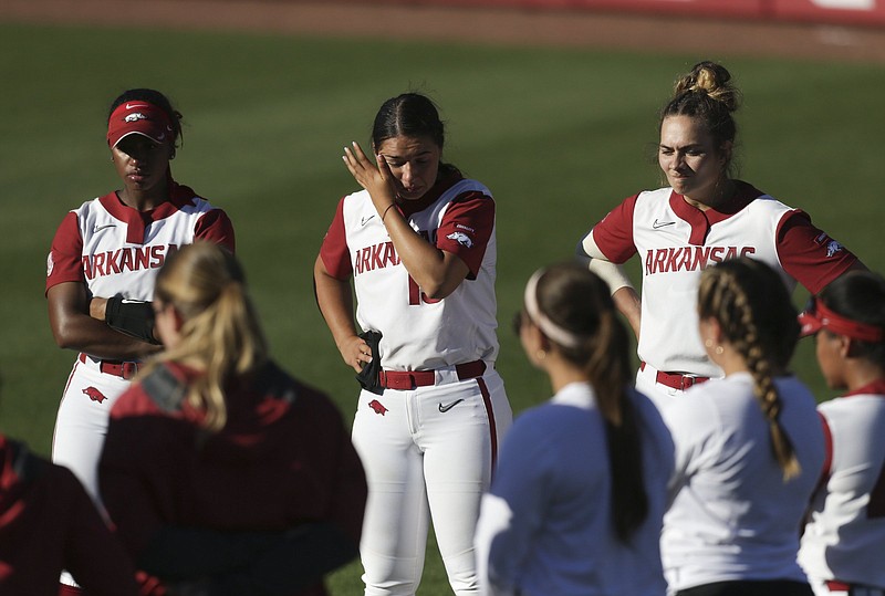 Arkansas outfielder Ryan Jackson (1), catcher Kayla Green (13) and pitcher Autumn Storms (9) react, Saturday, May 29, 2021 following a loss in Game 2 of the NCAA Super Regional at Bogle Park in Fayetteville. Arkansas finishes their season with a 4-1 loss against Arizona. Check out nwaonline.com/210530Daily/ for today's photo gallery. .(NWA Democrat-Gazette/Charlie Kaijo)