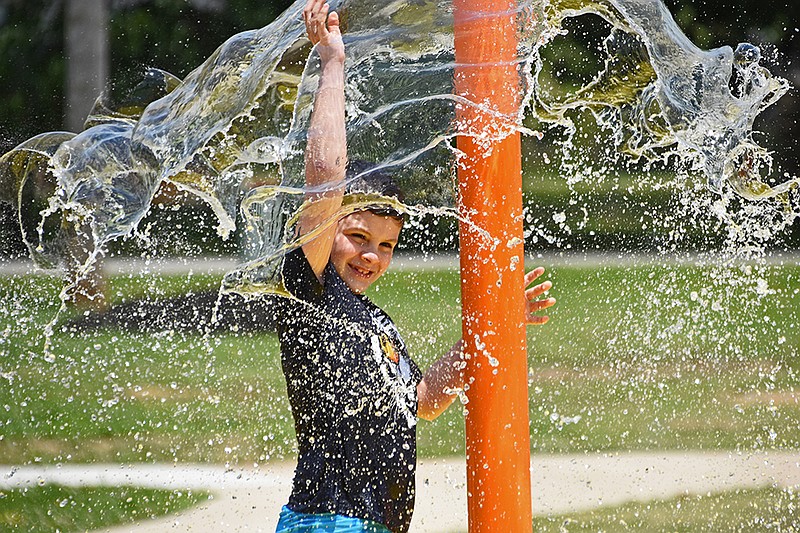 Dexter Barber, 8, plays in the splash pad Sunday afternoon during Peace at the Park, a community event to promote unity and equality, hosted by Future Through the People and other community partners at 5th Avenue Park in Conway. See more photos at arkansasonline.com/531peace/..(Arkansas Democrat-Gazette/Staci Vandagriff)