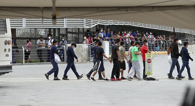 Several immigrants are escorted from an immigration bus Wednesday on the Hidalgo International Bridge in Hidalgo, Texas.
(AP/The Monitor/Delcia Lopez)