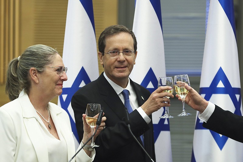 President-elect Isaac Herzog and his wife, Michal, celebrate Wednesday after a special session of the Knesset, Israel’s parliament, where lawmakers elected the new president in Jerusalem.
(AP/Ronen Zvulun)
