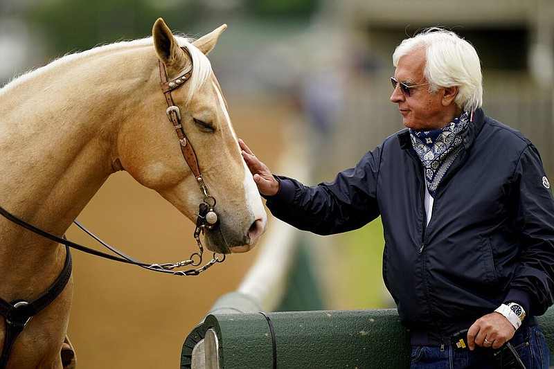 Trainer Bob Baffert pets an outrider's horse while watching workouts at Churchill Downs in Louisville, Ky., in this April 28, 2021, file photo. (AP/Charlie Riedel)