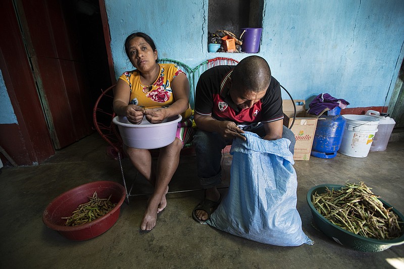 Alvina Jeronimo Perez and her husband, Anibal Garcia, peel beans that they grew themselves to cook an early lunch in December at their home in Tizamarte, Guatemala. Jeronimo made a failed attempt to migrate last year to the U.S. in part to pay off a loan for the addition to their single-story concrete block house, which Garcia built on land passed down from Perez's great-grandparents.
(AP/Moises Castillo)