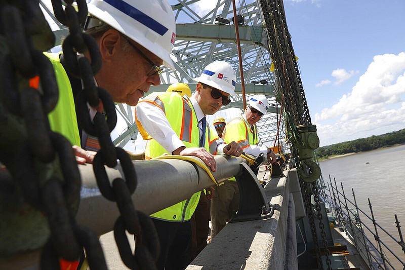 Transportation Secretary Pete Buttigieg (center) gets a look at the cracked beam on the Hernando De Soto Bridge on Thursday with U.S. Rep. Steve Cohen, D-Tenn., (left) and other officials. The span over the Mississippi River on Interstate 40 between West Memphis and Memphis has been closed since May 11.
(AP/The Commercial Appeal/Joe Rondone)