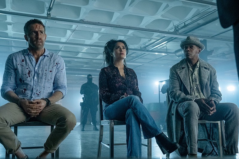 Running it back: Unlicensed bodyguard Michael Bryce (Ryan Reynolds), infamous international con artist Sonia Kincaid (Salma Hayek) and murderer for money Darius Kincaid (Samuel L. Jackson) fi nd themselves at the center of a global plot to do bad things in the action comedy “The Hitman’s Wife’s Bodyguard,” a sequel to 2017’s “The Hitman’s Bodyguard.”