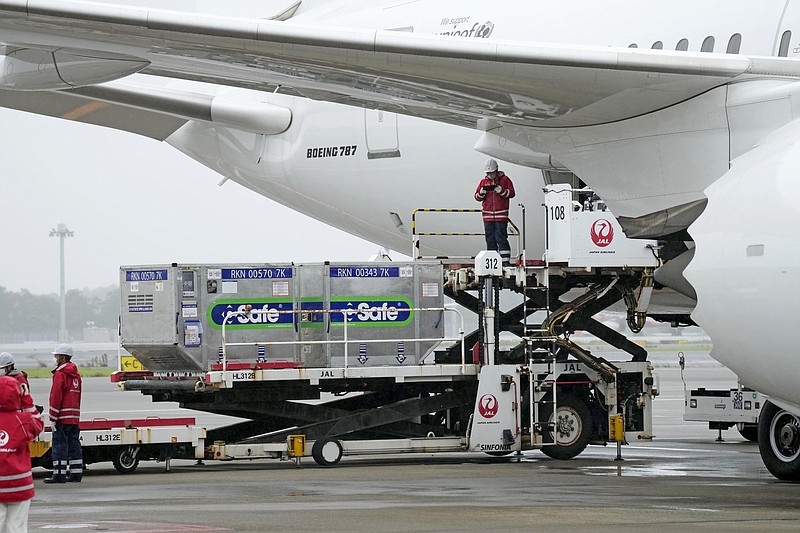 Containers of coronavirus vaccine doses donated by the Japanese government are loaded onto a plane Friday at Narita International Airport before the plane departs for Taiwan.
(AP/Kyodo News/Sadayuki Goto)