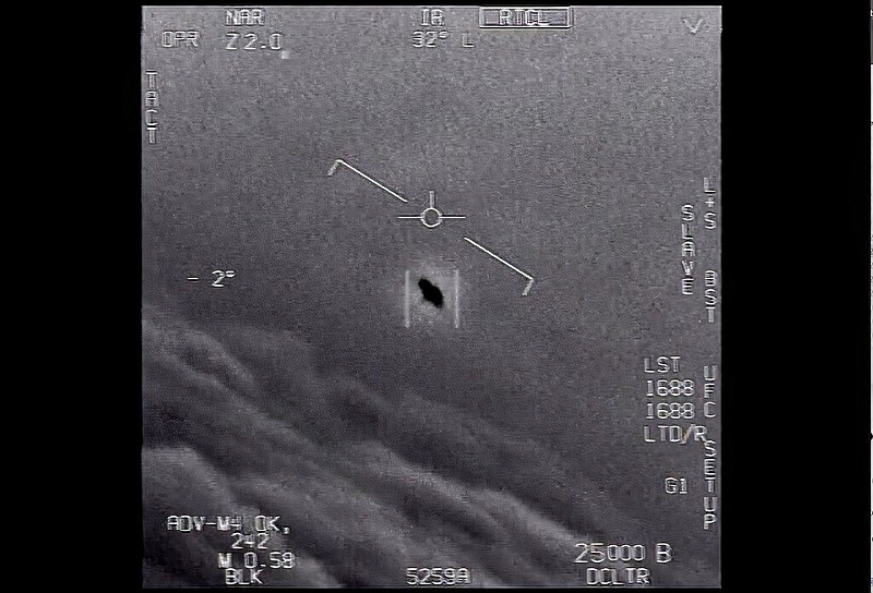 In this image from video provided by the U.S. Department of Defense from 2015, an unexplained object is seen at center as it is tracked as it soars high along the clouds, traveling against the wind. “There's a whole fleet of them,” one naval aviator tells another, though only one indistinct object is shown. “It's rotating." (Department of Defense via AP)