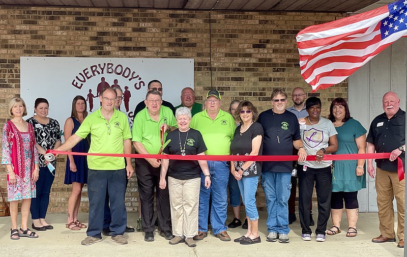 From left, Judy Ward, Tiffany Olson, Brandi Camp, Roy Watkins, Michael O’Connell, Larry D. Anderson (cutting ribbon), Steve Loggins (back row), Robin Anderson, Byron Winn, Danny Rolland, Evette Atchinson, Randy Atchinson, Justin Howard, Janice Hicks, Alexis Alexander and Bill Luther. (Marvin Richards/News-Times)