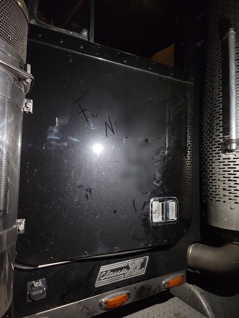 The phrase “f### n######” and a swastika were drawn on the side of Biddle and Sons Trucking LLC vehicles in a vandalism incident earlier this week. The air intake systems were damaged on four trucks, and an investigation into the incident is ongoing. (Contributed)