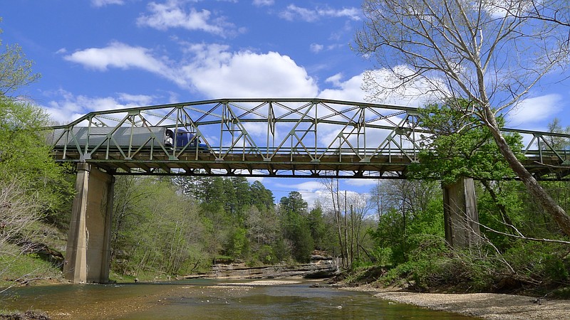 A truck on Scenic Arkansas 7 in rural Newton County drives over the Buffalo National River bridge at Pruitt in this April 14, 2016, file photo. The two-lane Pruitt bridge was built in 1931 and, before its scheduled destruction in June 2021, was the last Pennsylvania through-truss bridge remaining in Arkansas. (Arkansas Democrat-Gazette/Bill Bowden)