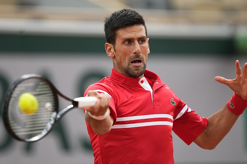 Serbia's Novak Djokovic returns a forehand to Italy's Matteo Berrettini during their quarterfinal match of the French Open tennis tournament at the Roland Garros stadium Wednesday, June 9, 2021 in Paris. (AP Photo/Michel Euler)