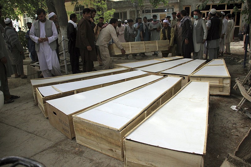 The coffins of people killed in an attack on a de-mining camp late Tuesday are placed on the ground Wednesday outside a hospital in northern Baghlan province, Afghanistan.
(AP/Mehrab Ibrahimi)