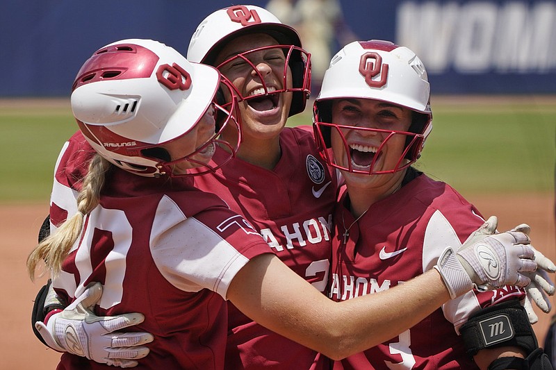 Oklahoma’s Jayda Coleman (center), Grace Lyons (right) and Jana Johns celebrate after Coleman’s home run in the second inning of the Sooners’ victory over Florida State on Thursday in the final game of the Women’s College World Series.
(AP/Sue Ogrocki)