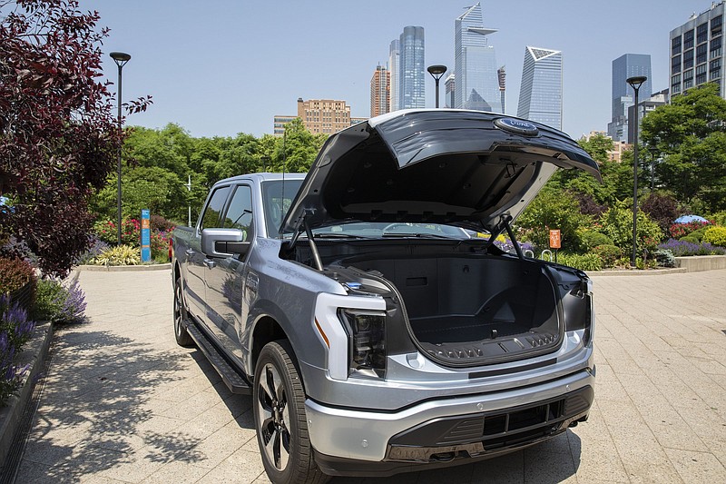 An electric Ford F-150 Lightning sits on display in New York City  last month. The pickups are set to roll off the assembly line next  year at a new high-tech factory at Ford’s Rouge complex in Dear- born just outside Detroit.
(AP)