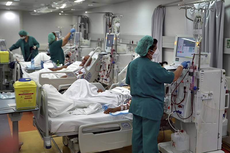 A nurse checks a patient undergoing dialysis Thursday at the Lebanese American University Medical Center-Rizk Hospital in Beirut. More photos at arkansasonline.com/611covid19/.
(AP/Bilal Hussein)