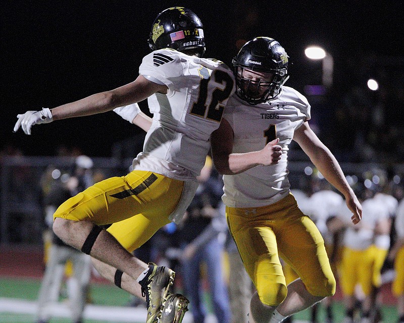 FILE -- In this file photo, Prairie Grove Tigers Junior Landon Semrad (12) and Senior Cade Grant (1) celebrates a touchdown during the game against the Elkins Elks Friday, November 6, 2020, at John Bunch Stadium, Elkins, Arkansas (Special to NWA Democrat-Gazette/Brent Soule)