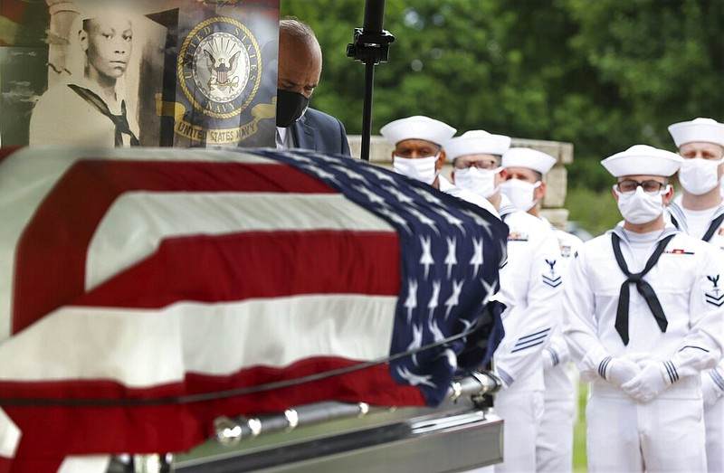 The casket with the remains of Mess Attendant 3rd Class Isaac Parker, 17, is positioned during his funeral ceremony with full military honors at Jefferson Barracks National Cemetery, in St. Louis County, Mo., on Tuesday, June 8, 2021. (Christian Gooden/St. Louis Post-Dispatch via AP)