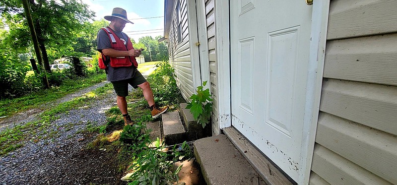 Hansen Doolittle, the team leader for Missouri and Arkansas American Red Cross, assesses a home in Stuttgart with a visible waterline on the front door. 
(Pine Bluff Commercial/Eplunus Colvin)