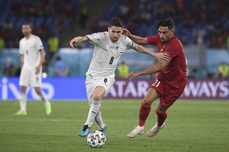 Italy’s Jorginho (left) fights for the ball with Turkey’s Irfan Kahveci during the European Championship soccer match between the two countries on Friday in Rome. Italy defeated Turkey 3-0 in the opening match of Euro 2020, which was postponed by a year because of the coronavirus pandemic.
(AP/Alberto Lingria)