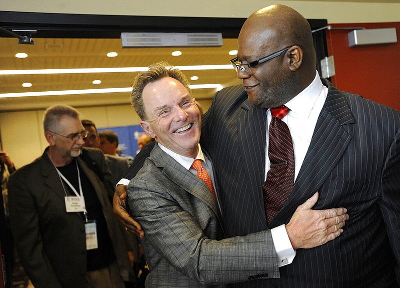 FILE - In this Tuesday, June 10, 2014 file photo, the Rev. Ronnie Floyd, center, of Cross Church in northwest Arkansas, hugs the Rev. Dwight McKissic, right, of Cornerstone Baptist Church in Arlington, Texas, after Floyd was elected the new president of the Southern Baptist Convention during its annual meeting in Baltimore. Ahead of the June 2021 meeting, Asian American and Hispanic participation increased, prompting Floyd to hail America’s diversity as “an amazing opportunity" for future growth. (AP Photo/Steve Ruark)