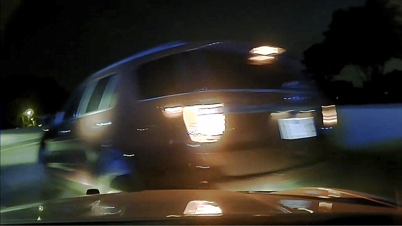 This screen shot taken from dashcam video owned by the Arkansas State Police shows the moment before a woman's car flipped over in Pulaski County in July 2020. The dashcam was in a vehicle driven by Arkansas State Police trooper Rodney Dunn. The woman is suing the state police after she says the trooper crashed into her car, causing it to flip, after she didn't immediately pull over for a traffic stop. (Arkansas State Police via AP)